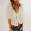 FJØRNA women's cotton blouse with ruffle detail, stylish tops for women, shown in a close-up image.