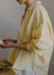 FJØRNA linen shirt with slit hem detail, natural lightweight fabric, relaxed fit, and stylish design for casual wear.