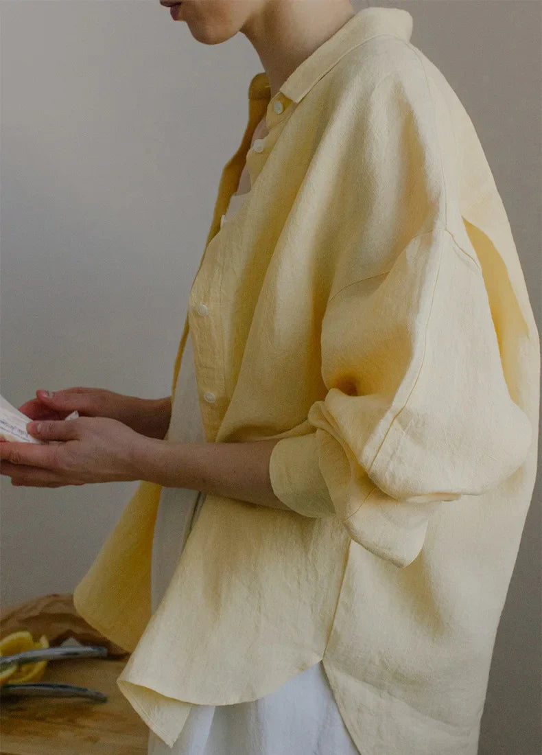 FJØRNA linen shirt with slit hem detail, natural lightweight fabric, relaxed fit, and stylish design for casual wear.