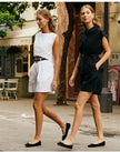 FJØRNA women's linen crop top with short sleeves and V-neck, featuring a lightweight, breathable fabric in natural linen color.