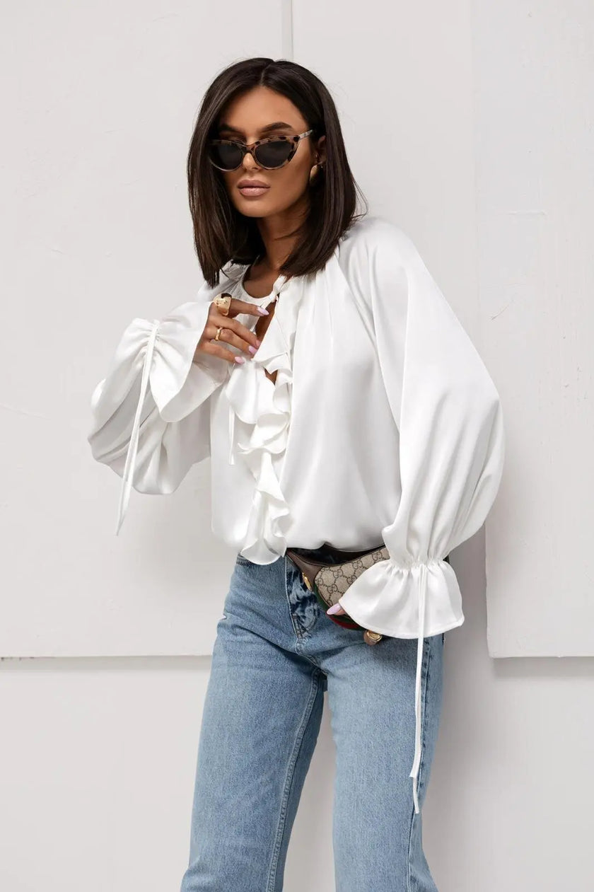 FJØRNA satin women's blouse with ruffle detail, showcasing elegant, smooth fabric and feminine design.