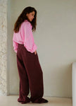 FJØRNA women’s linen blend wide-leg high-waist trousers displayed on a model, showcasing relaxed fit and stylish design.