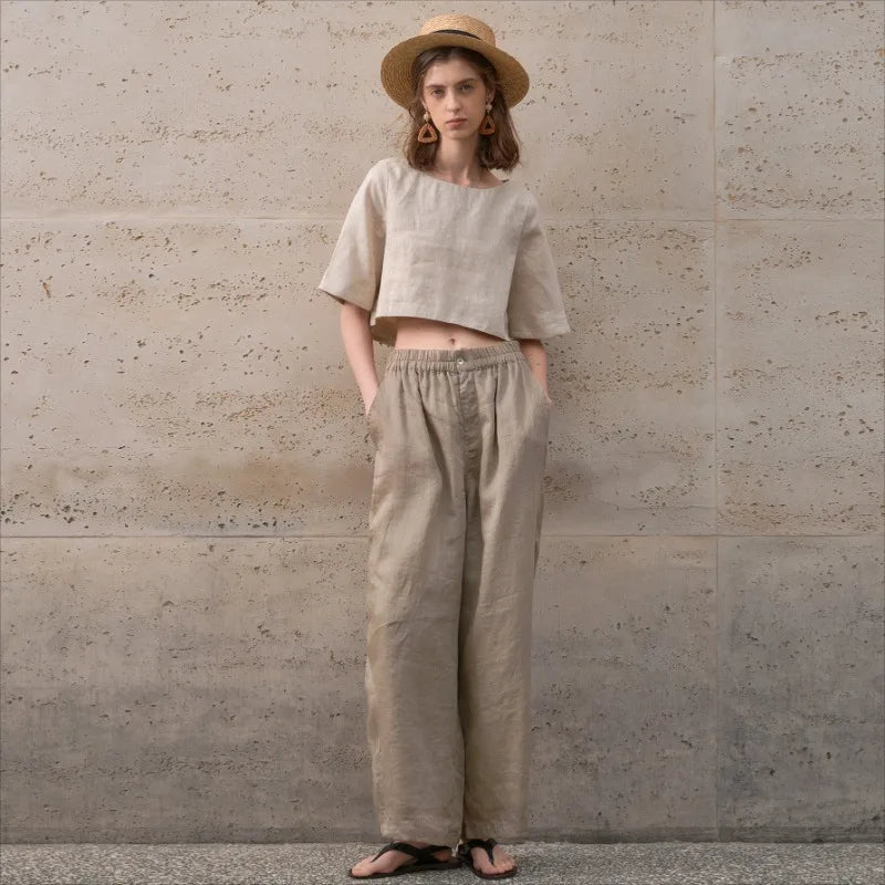 FJØRNA women's linen crop top with short sleeves, lightweight and breathable, shown in a natural fabric texture.