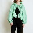 FJØRNA women's cotton blouse featuring ruffle detail, lightweight and stylish top, ideal for casual or dressy outfits