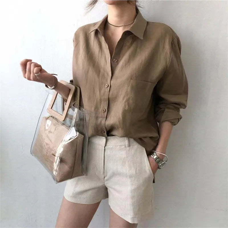 Women’s linen shirt with open collar by FJØRNA, featuring a lightweight, breathable top perfect for casual or summer wear.