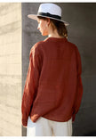 Light beige linen women's V-neck shirt from FJØRNA, featuring a relaxed fit and soft fabric for casual comfort.