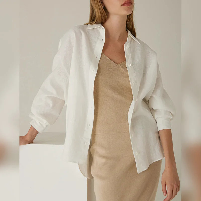 FJØRNA women's knit shirt with slit hem, long sleeves, and fitted style, displayed on a neutral background.