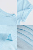 FJØRNA oversized tee featuring rolled cuffs, soft fabric, and relaxed fit, shown in a casual style.