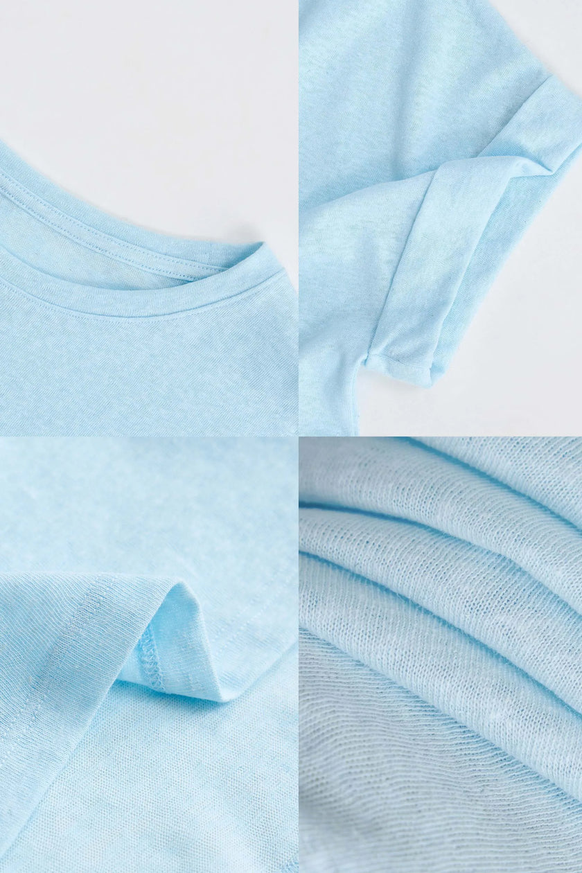 FJØRNA oversized tee featuring rolled cuffs, soft fabric, and relaxed fit, shown in a casual style.