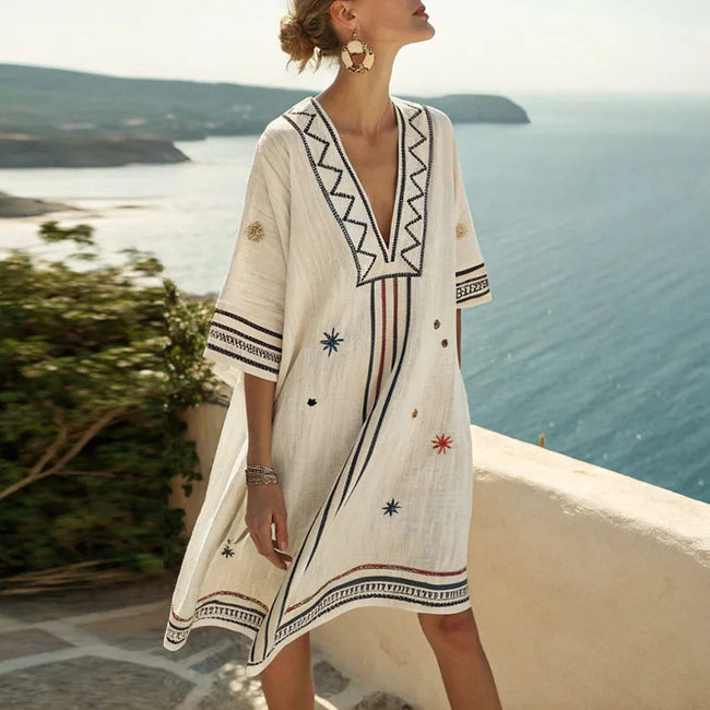 FJØRNA summer floral maxi dress for women with V-neck, flowing fabric, displaying a vibrant floral pattern and sleeveless design.
