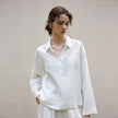 FJØRNA women's linen polo top with collar, light and breathable fabric, shown in a stylish women's top with a classic collar design.