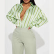 FJØRNA women's satin blouse, elegant long-sleeve top with a smooth, shiny fabric and classic collar, shown on a hanger.