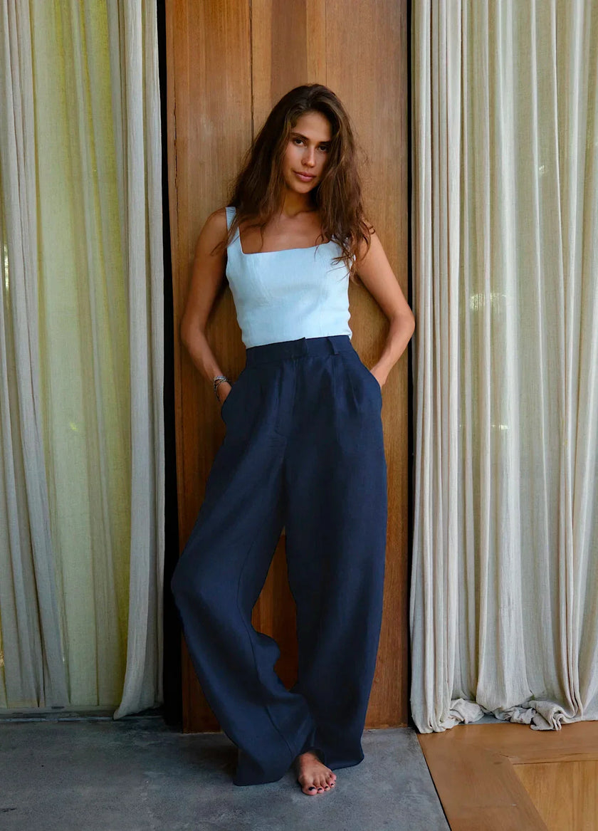 FJØRNA women's linen blend wide-leg high-waist trousers, light and breezy with a relaxed fit, shown on a model.