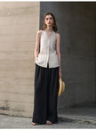 FJØRNA women's linen waistcoat with halter neck and sleeveless design, shown as a stylish top in a natural fabric look.
