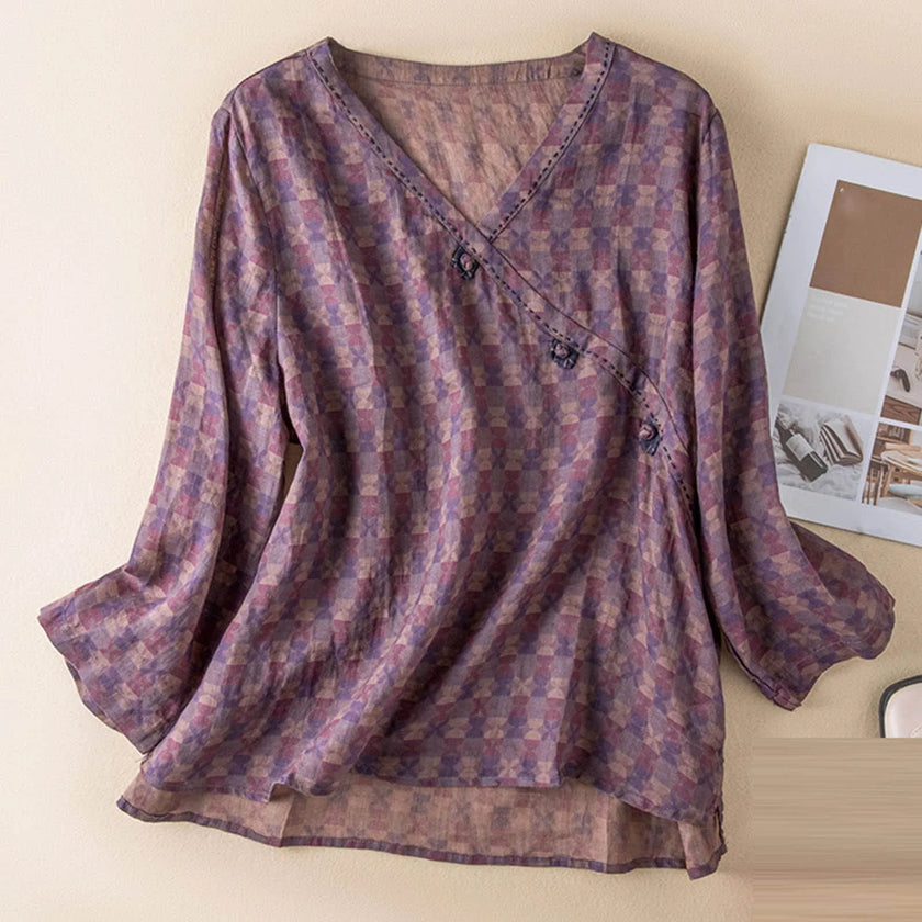 FJØRNA Kaien wrap-style blouse with long sleeves and V-neck, featuring a stylish, flowy fabric in a versatile design.