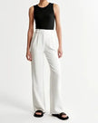Women’s wide-leg high-waist trousers by FJØRNA, featuring a relaxed fit and stylish design in neutral fabric.
