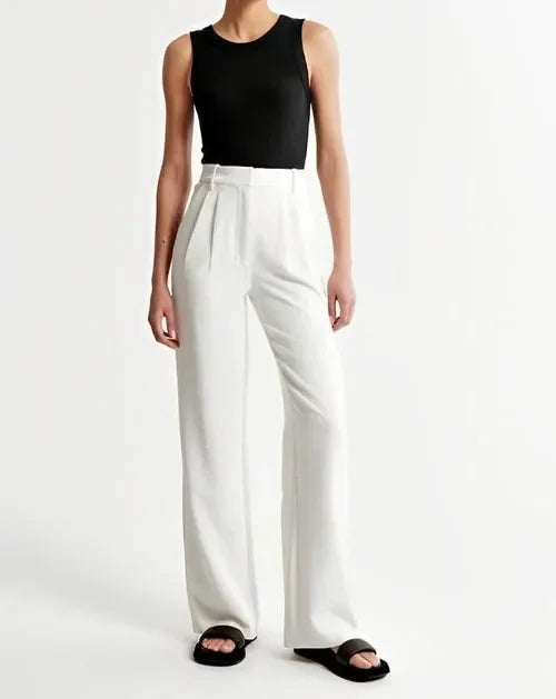 Women’s wide-leg high-waist trousers by FJØRNA, featuring a relaxed fit and stylish design in neutral fabric.