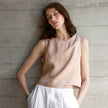 Light beige linen crop top for women by FJØRNA, featuring a fitted design and short sleeves.