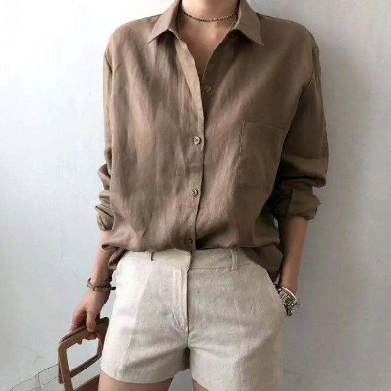 FJØRNA women's linen shirt with open collar, lightweight and breathable top, styled casually on a model.