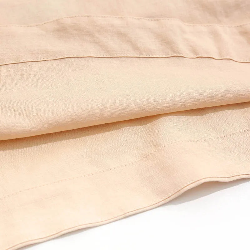 FJØRNA square neck linen cropped tank top in neutral color, close-up showing textured fabric and stylish neckline.