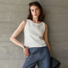 FJØRNA women's linen crop top, lightweight and breathable, shown in natural beige with short sleeves and a relaxed fit.