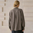 Women’s linen blend shirt by FJØRNA, lightweight and breathable top with a relaxed fit, shown in a natural fabric texture.