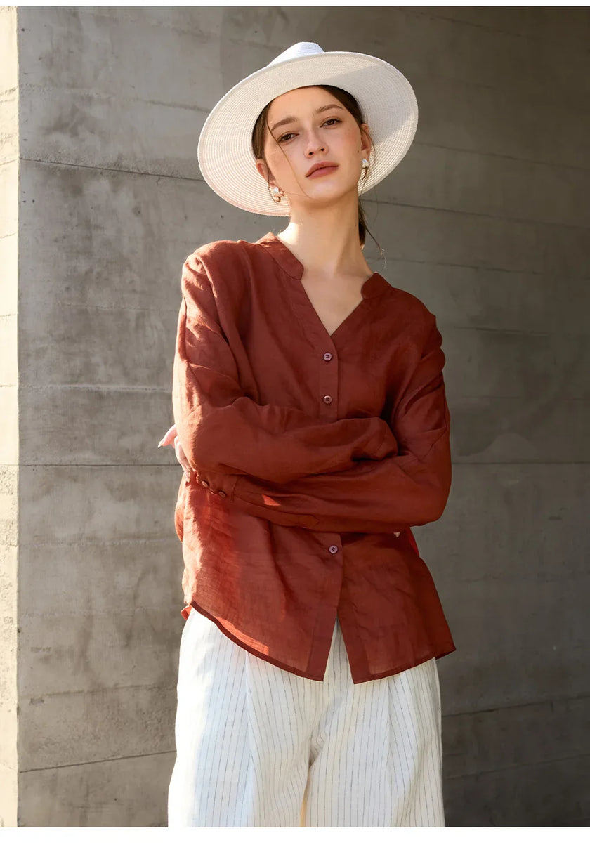 Women’s linen V-neck shirt by FJØRNA, light and breathable top with a relaxed fit, shown in a natural fabric texture.