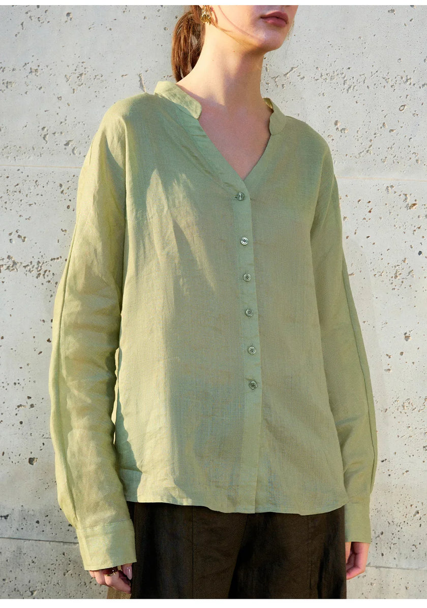 FJØRNA women's linen V-neck shirt, lightweight and breathable top, shown in a soft natural fabric with a relaxed fit.