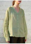 FJØRNA women's linen V-neck shirt, lightweight and breathable, shown in a neutral color with a relaxed fit.