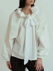 FJØRNA women's cotton blouse with ruffle detail, featuring a stylish and breathable top ideal for casual or dressy wear.