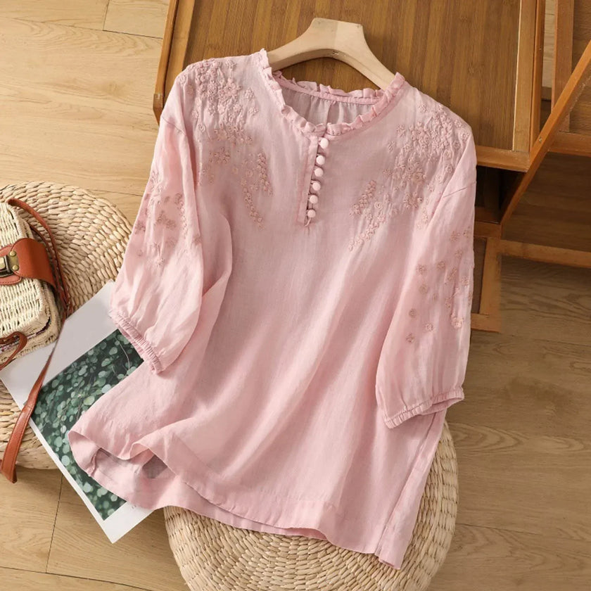 FJØRNA women's floral summer blouse with V-neck, linen fabric, and ruffle details, perfect for warm-weather casual wear.