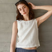 Light beige linen crop top for women by FJØRNA, featuring a fitted style and short sleeves, casual summer fashion.