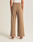 Wide-leg high-waist women's trousers by FJØRNA, featuring a relaxed fit and stylish design in a neutral fabric.