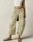 FJØRNA women's wide-leg denim jeans displayed on a hanger, showcasing their relaxed fit and classic blue denim fabric.