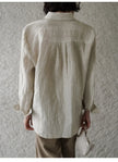 FJØRNA women's linen pleated shirt showcasing lightweight, breathable fabric with a relaxed fit and stylish pleats.