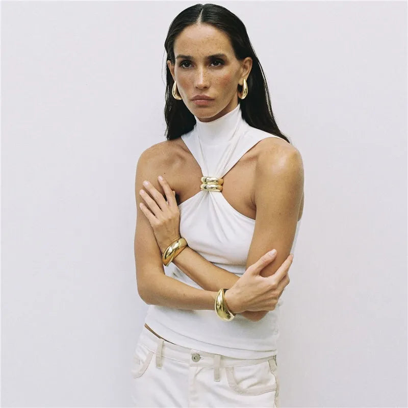 FJØRNA women's silk halter neck top displayed on a model, featuring smooth fabric and stylish design perfect for elegant casual wear.