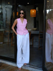 Women’s linen blend wide-leg trousers by FJØRNA featuring high waist and relaxed fit, shown in natural beige fabric.