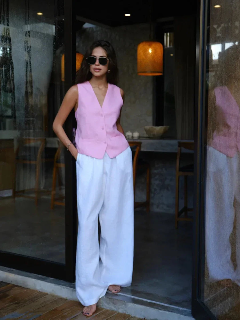 Women’s linen blend wide-leg trousers by FJØRNA featuring high waist and relaxed fit, shown in natural beige fabric.