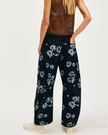 FJØRNA women's wide-leg denim jeans, stylish pants with a relaxed fit and classic blue wash, displayed on a neutral background.