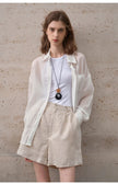 FJØRNA women's linen shirt, lightweight and breathable top with a relaxed fit, shown in natural fabric and casual style.