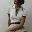 FJØRNA women's cotton polo top, lightweight and classic design, featuring a collared neckline and short sleeves.