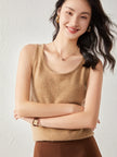 FJØRNA women's cashmere top, soft and cozy with a relaxed fit, shown in a neutral color on a model.