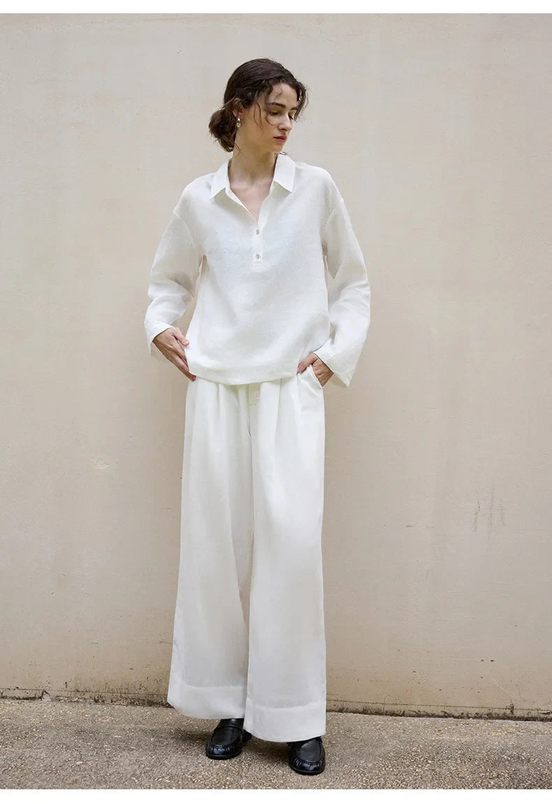 Women’s linen polo top by FJØRNA featuring a classic collar and short sleeves, styled on a model.