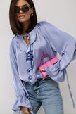 FJØRNA women's satin blouse with ruffle detail, stylish top featuring a smooth, shiny fabric and elegant design.
