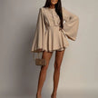 FJØRNA white mini dress with a sleek, fitted design, perfect for casual or dressy occasions, shown on a model.