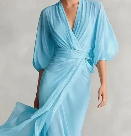 Powder blue FJØRNA dress with a flowing design, featuring a stylish silhouette and elegant fabric for a sophisticated look.