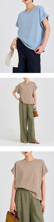 FJØRNA oversized tee with rolled cuffs, relaxed fit, soft fabric, and casual style, shown in a neutral color on a model.