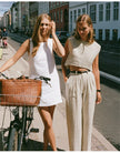 FJØRNA women's linen crop top featuring a light, breathable fabric with a relaxed fit and sleeveless design.