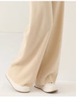 FJØRNA women’s merino wool wide-leg jogger pants, cozy and stylish, shown in black on a model.