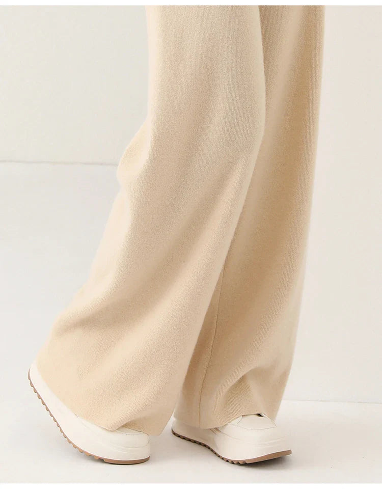 FJØRNA women’s merino wool wide-leg jogger pants, cozy and stylish, shown in black on a model.